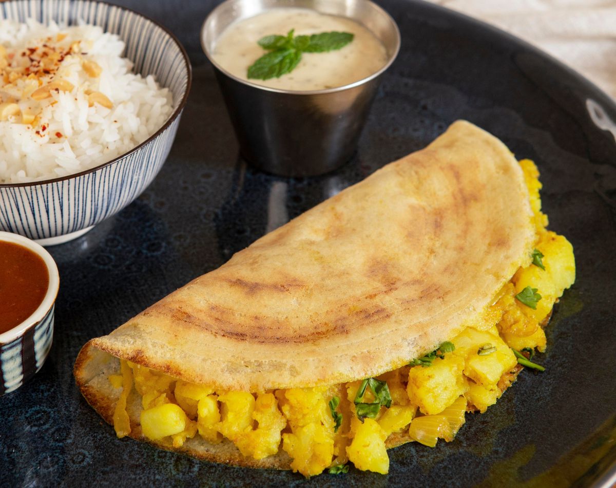 
Vijamma's Signature Masala Dosa is a crispy, golden crepe made from fermented rice and urad dal batter, filled with a flavorful, spiced potato masala. It is the perfect blend of crunch, spice, and tradition, and a beloved breakfast or snack in South India