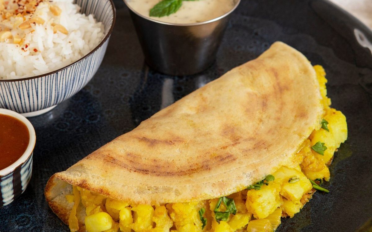 Vijamma's Signature Masala Dosa is a crispy, golden crepe made from fermented rice and urad dal batter, filled with a flavorful, spiced potato masala. It is the perfect blend of crunch, spice, and tradition, and a beloved breakfast or snack in South India